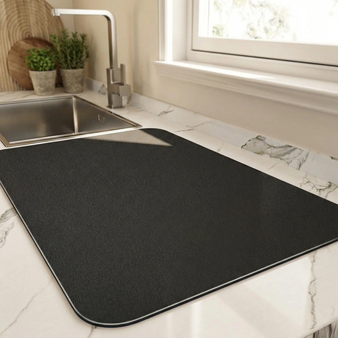 Absorbent quick-dry kitchen dish mat for countertops. Non-slip protection keeps dishes secure & surfaces dry.
