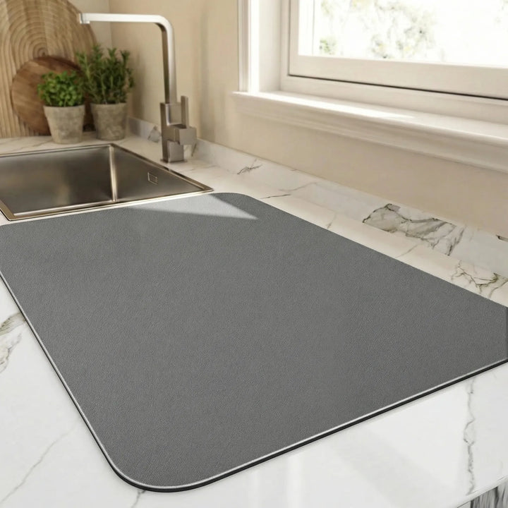 Kitchen mat for fast dish drying, featuring a wave design. Absorbent, non-slip, keeps countertops dry.