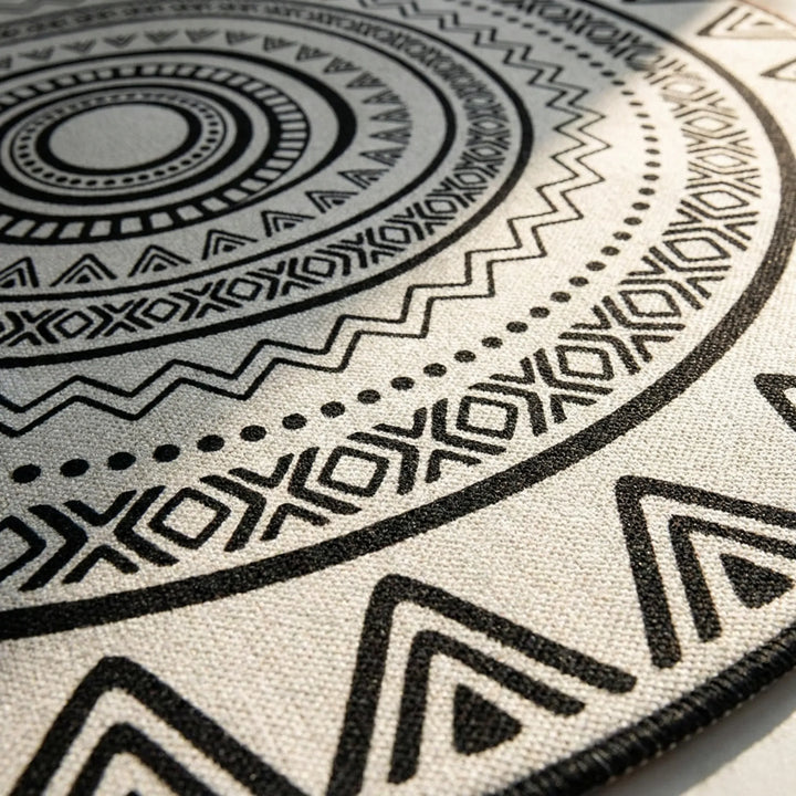 Round geometric Flowique area rug with abstract wave pattern, a washable and non-slip modern floor accent.