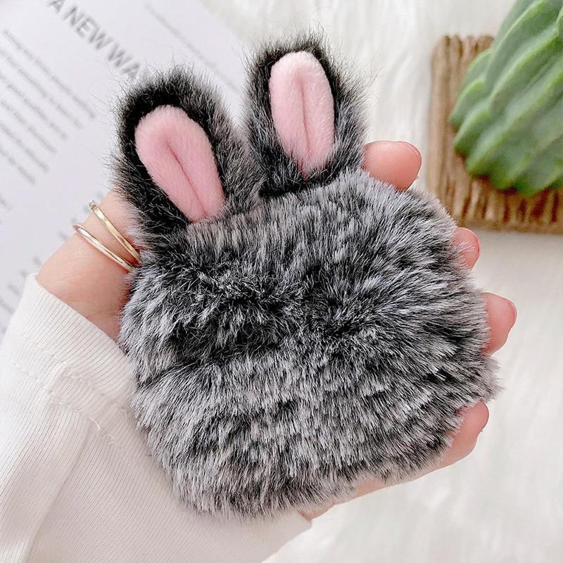 Grey fluffy earbud case, open showing interior, protective and shockproof accessory