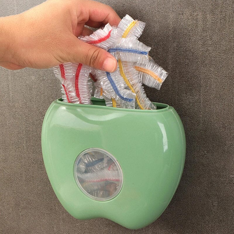Hands demonstrating use of the Food Wrap Dispenser, easily pulling out an elastic food cover for preservation