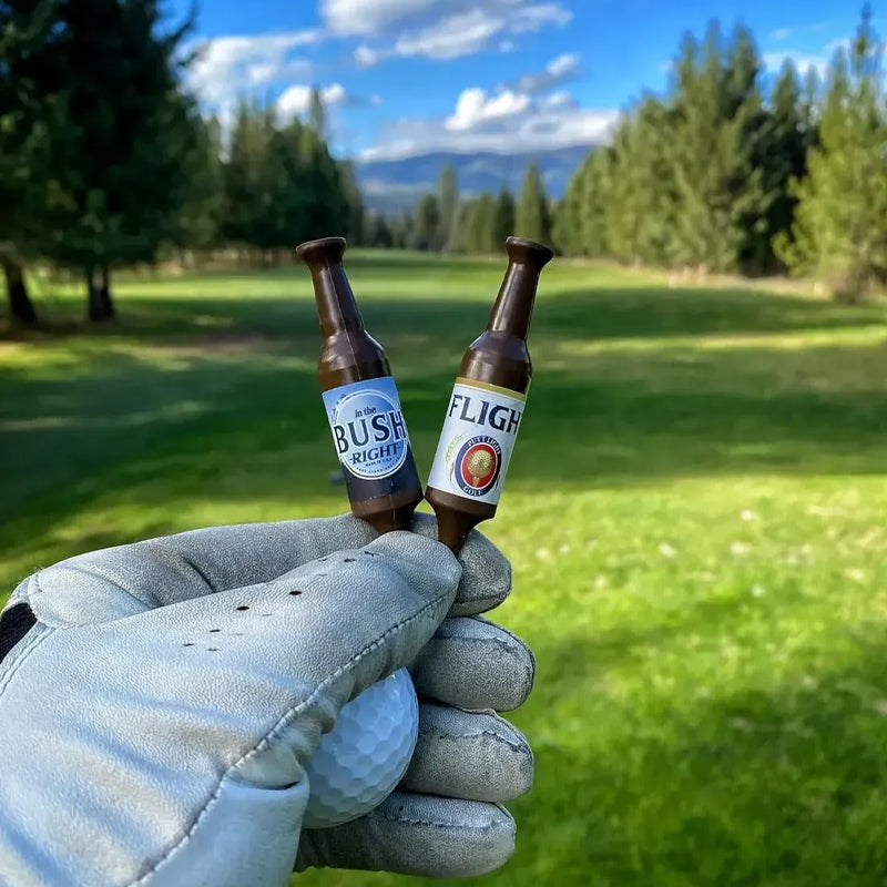 Novelty beer bottle golf tees displayed in a small, organized group, perfect for a gag gift.