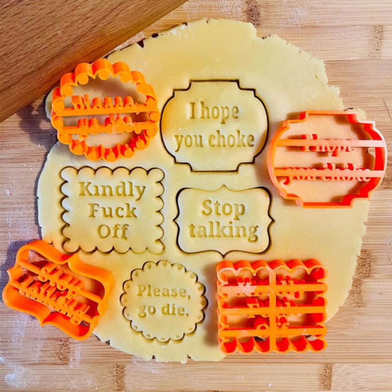 Four orange plastic cookie molds with fun phrases, ideal for DIY baking and novelty kitchenware.