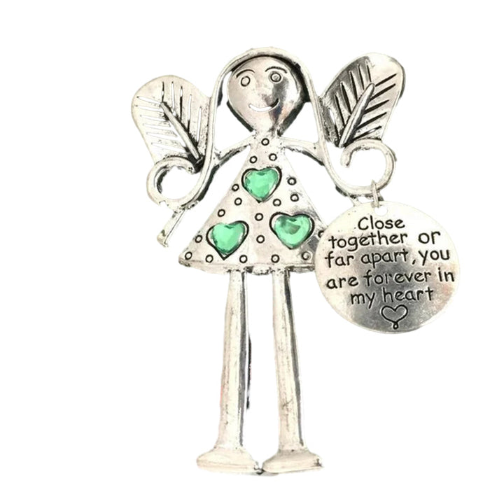 Hand holding Friendship Angel iron ornament, highlighting its unique design & sentimental value