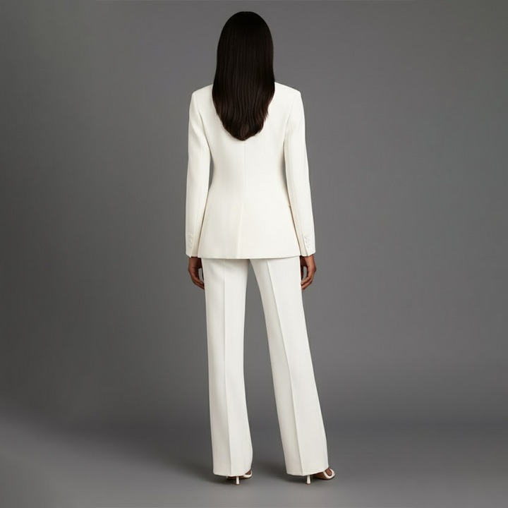 Elegant women's power suit with a longline blazer and matching trousers, ideal for office wear.