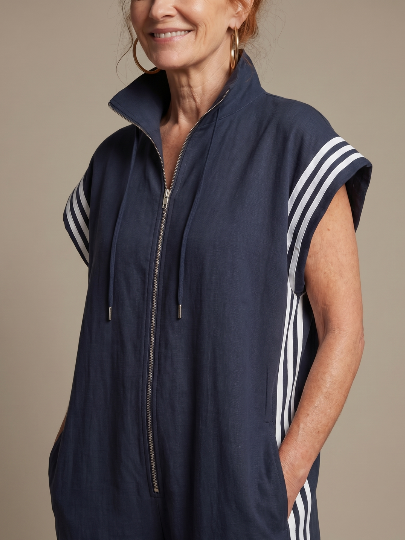 Full-length women's sporty jumpsuit, relaxed fit, zip front, prominent side stripe detail.