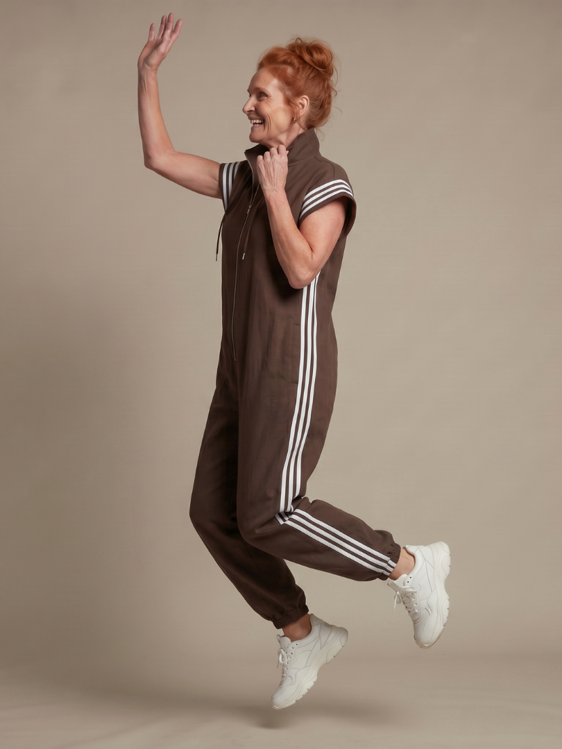 Relaxed full-length women's jumpsuit, cap sleeve, high neck, distinct sporty side stripe.