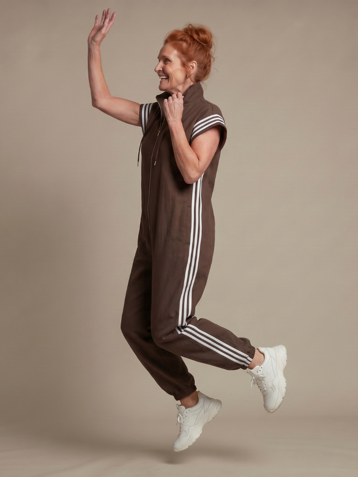 Relaxed full-length women's jumpsuit, cap sleeve, high neck, distinct sporty side stripe.
