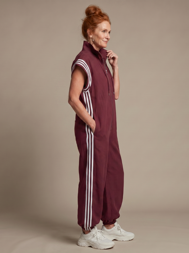 Sporty chic full-length women's jumpsuit with a relaxed fit and bold side stripe detail.