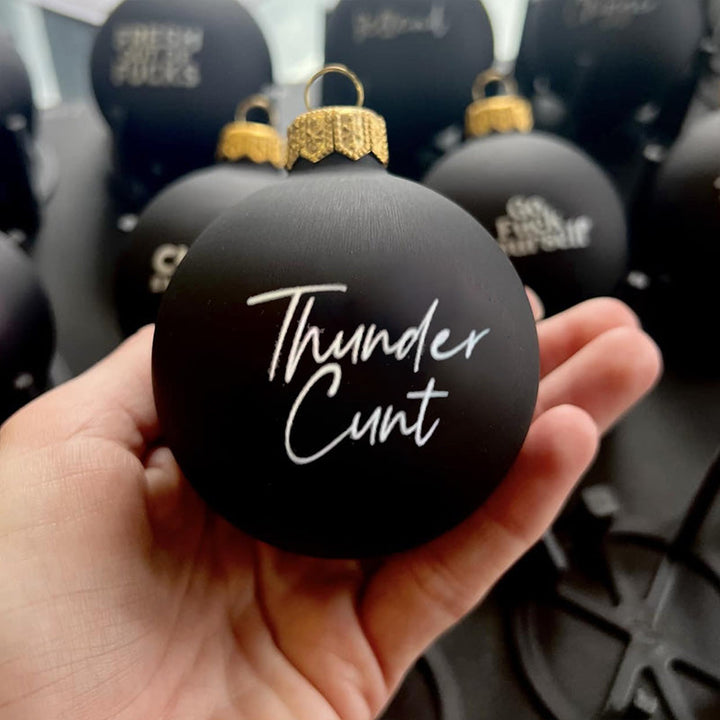 Novelty Christmas bauble with a naughty elf design, adult humor holiday decoration