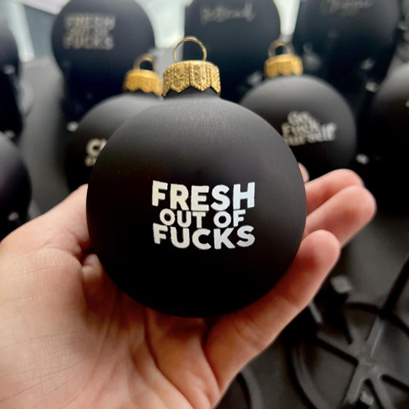 Fun and festive Christmas bauble with humorous adult saying, holiday party decor