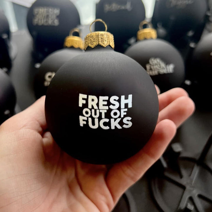 Fun and festive Christmas bauble with humorous adult saying, holiday party decor