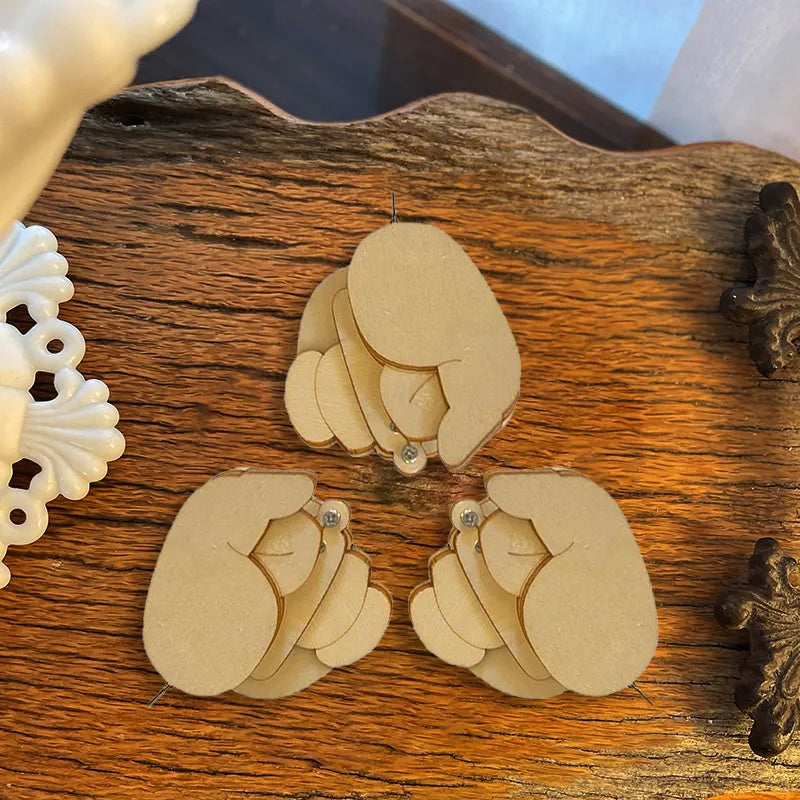 Close-up of a finished humorous wooden flippable finger brooch, a funny accessory and novelty pin.