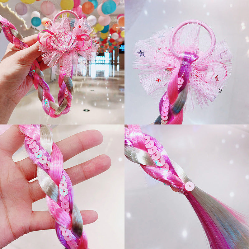 Child wearing long, rainbow-colored braided hair extensions, a fun girls' hair accessory