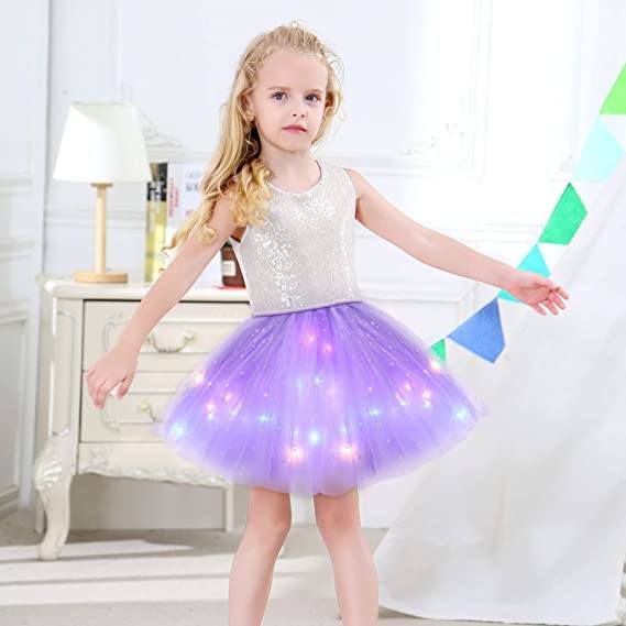 Close-up of LED lights on a girls' pink tutu skirt, glowing fabric detail, festive party wear