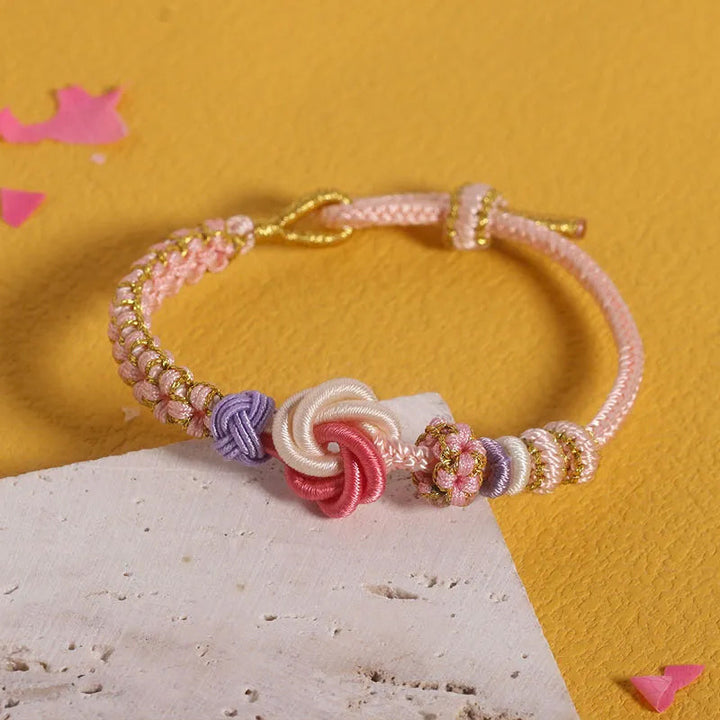 Packaging for girls' peach blossom knot braided bracelet, ready for gifting, perfect for kids jewelry