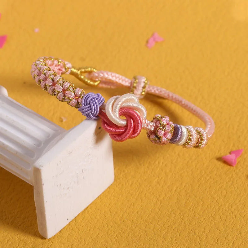 Detail of the braided cord on a peach blossom knot bracelet, soft texture, comfortable for young girls