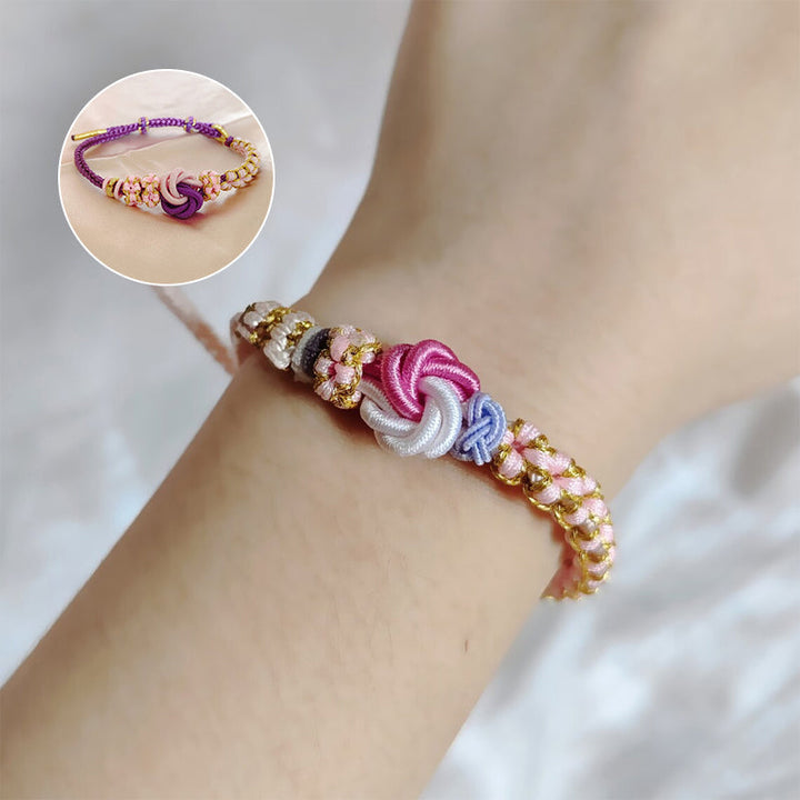 Close-up of peach blossom knot braided bracelet for girls, intricate detail, cheerful colors, adjustable
