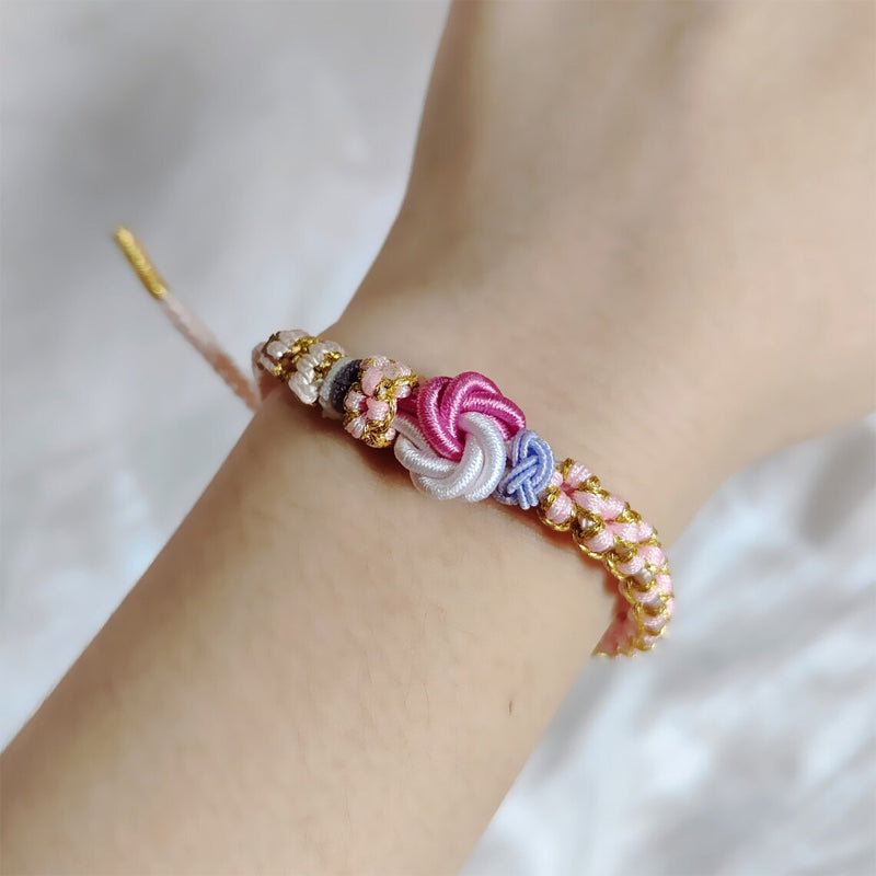 Peach blossom knot braided bracelet with charm, close up of the delicate knot work, gift for granddaughter