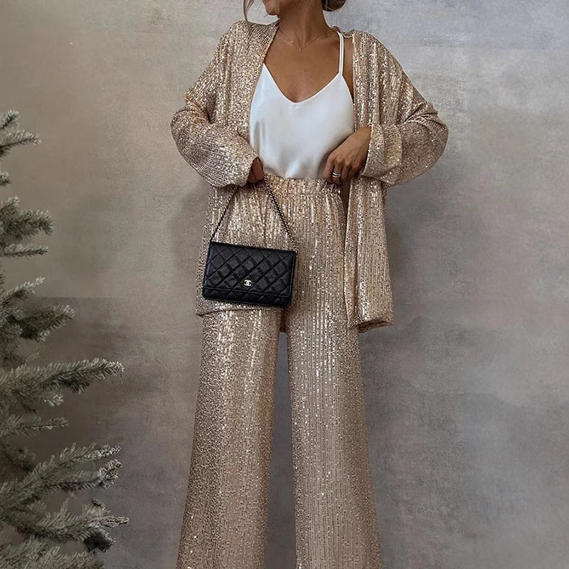 Women's dazzling sequin two-piece outfit with high-waisted trousers, ideal for evening and party wear.