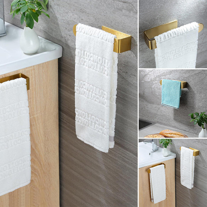 Adhesive towel bar made of stainless steel, gold finish for kitchen or bath.