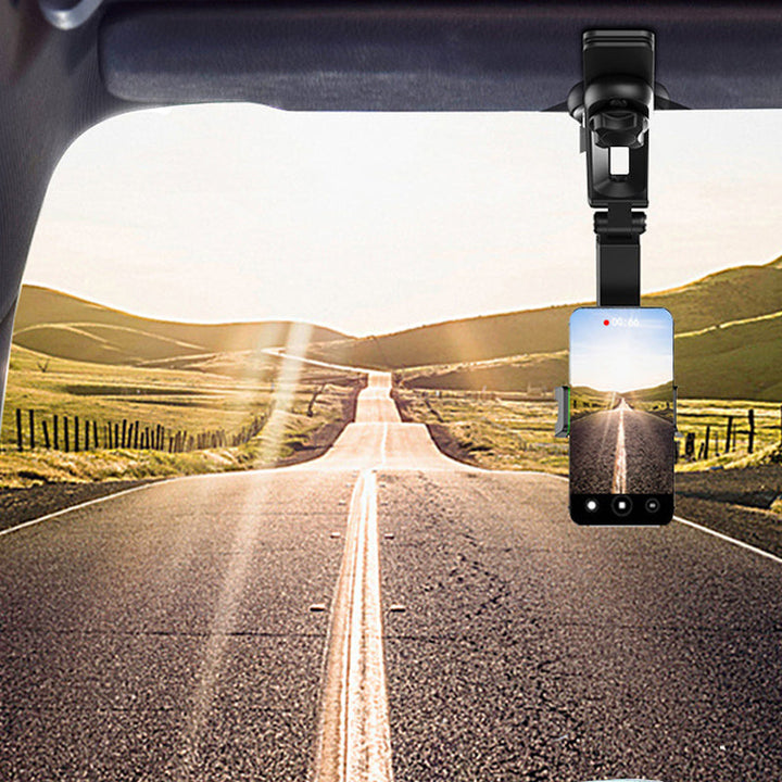 Automobile interior showing the gray phone mount installed on the sun visor, without phone.
