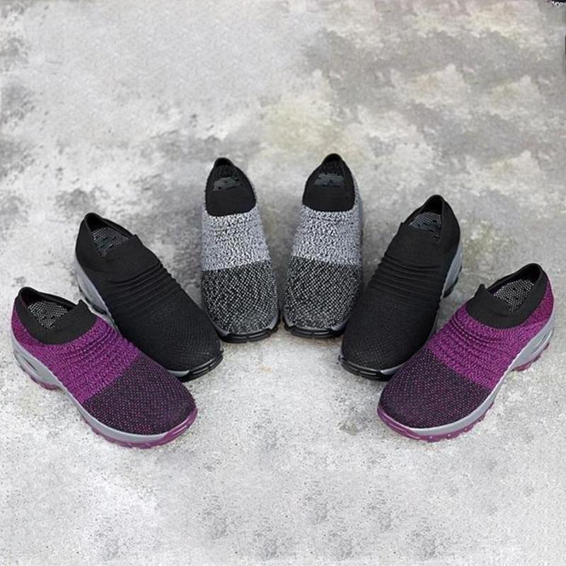 Pair of gray women's air cushion outdoor shoes, ideal for comfortable and breathable sportswear.