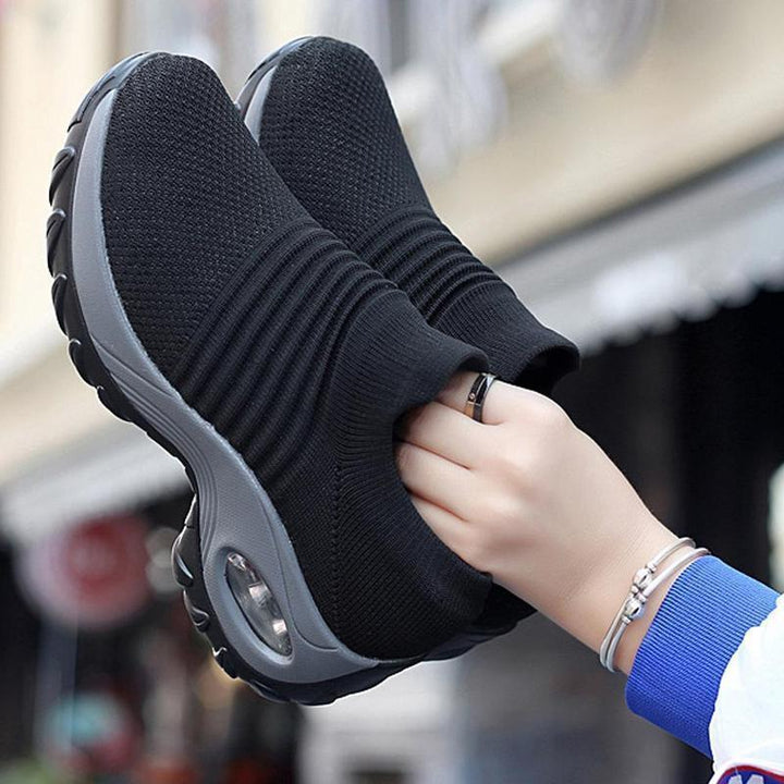 Close-up of the breathable mesh on purple women's air cushion outdoor athletic sneakers.