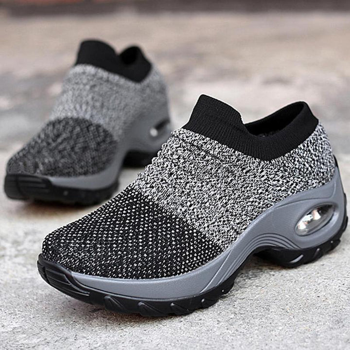 Model wearing gray women's air cushion outdoor shoes, demonstrating comfort and style.