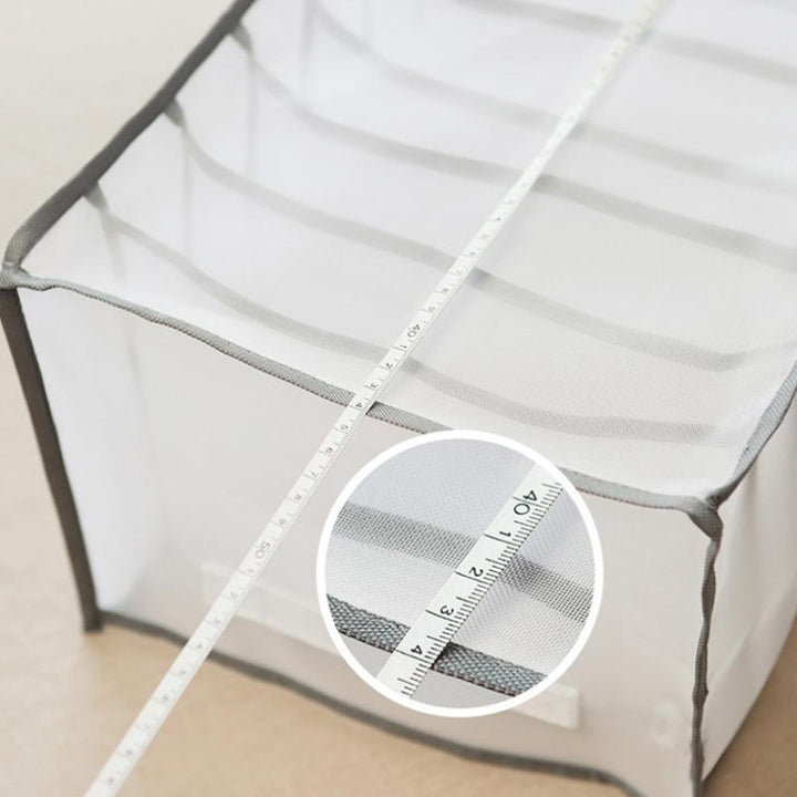 Collapsible fabric storage bins, empty and folded flat, highlighting space-saving design