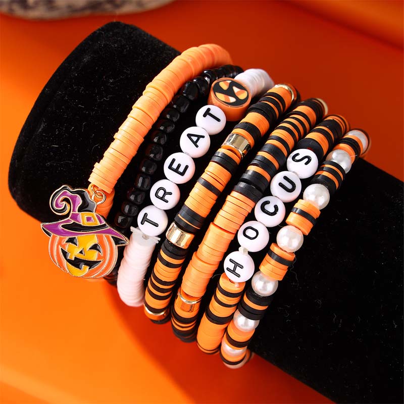 Beaded clay bracelets in Halloween colors, accented with ghost and pumpkin charms.