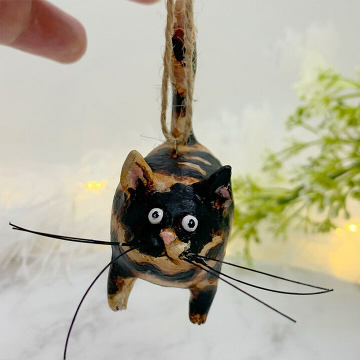 Small hand-sculpted cat art piece, capturing the essence of a charming feline companion.
