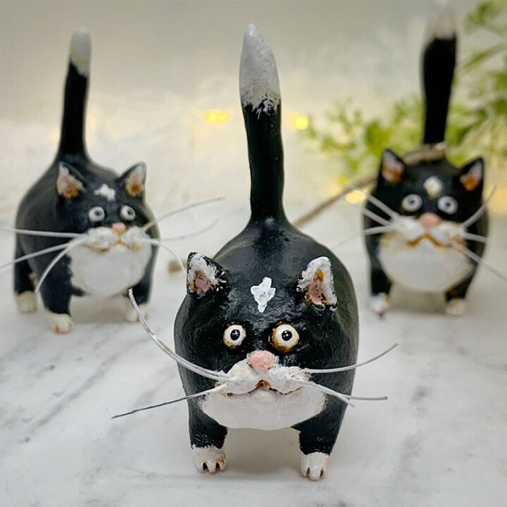 Delightful kitty miniature, a small hand-sculpted and painted animal figurine for display.