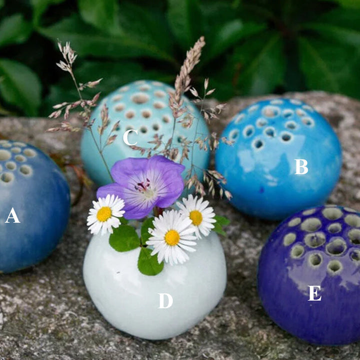 Handmade clear resin mini vase with delicate dried tiny flowers, perfect for tabletop decor
