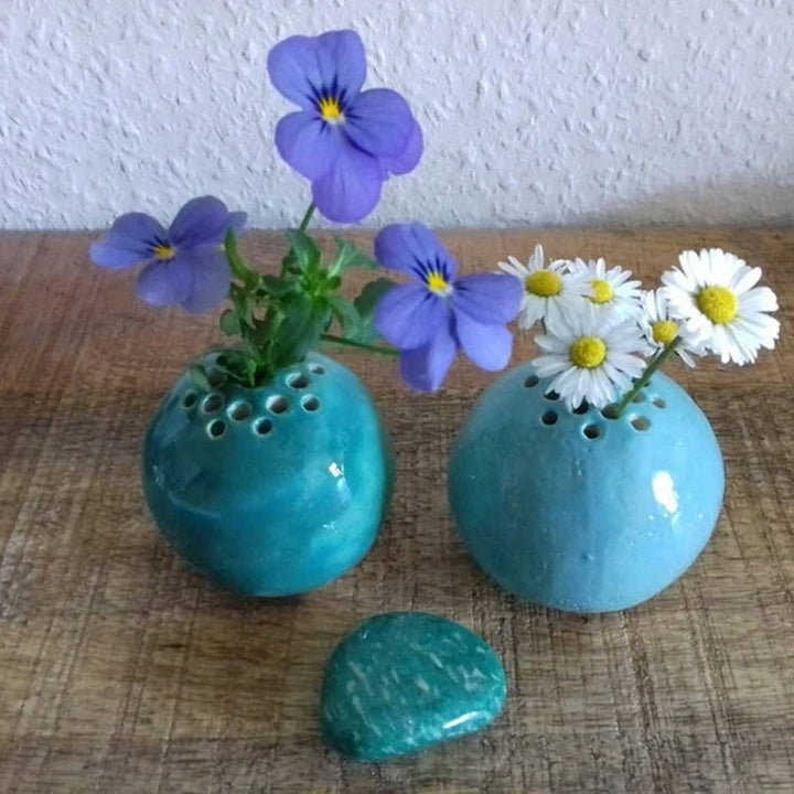 Stylish handmade resin mini vase with a subtle swirl design, showcasing its use for tiny blossoms