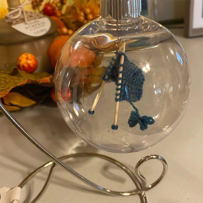 Close-up of a knitting-themed Christmas tree ornament, intricate yarn design, perfect for crafters