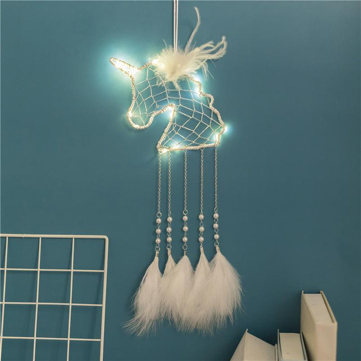 Handmade unicorn dream catcher for children's bedroom decor, featuring pastel colors and feathers.