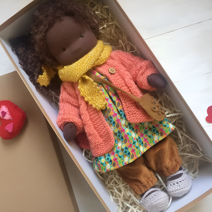 Natural cotton and wool Waldorf doll, a soft handmade cuddly toy.