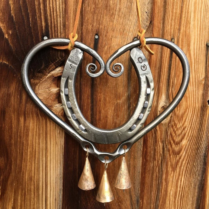Outdoor metal wind chime in a charming heart shape, adding a touch of romance to any garden.