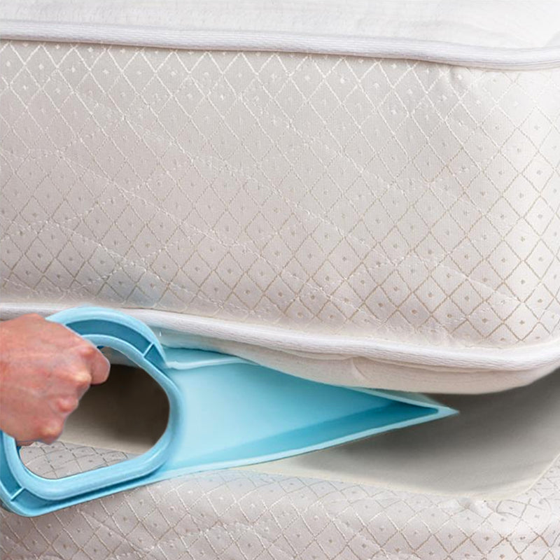 Close-up of the mattress lifter wedged under a mattress, simplifying bed making process