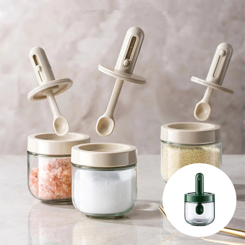 Glass seasoning dispenser with attached spoon for easy kitchen spice storage & use