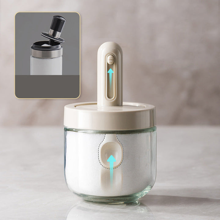 Modern glass spice dispenser with attached spoon for organized, efficient kitchen use