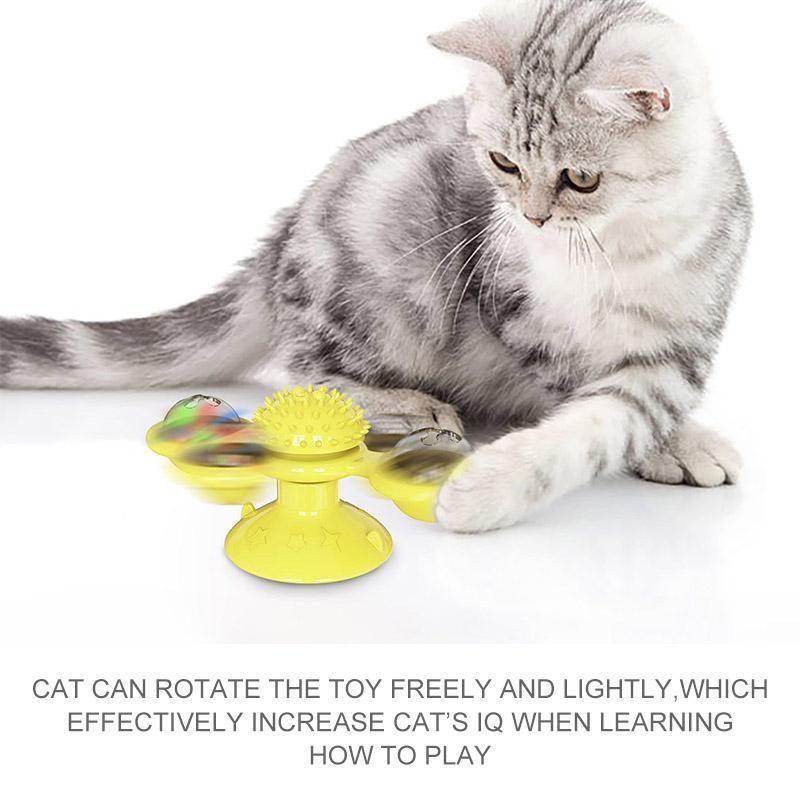 Playful cat interacting with blue Windmill Toy, suctioned to a smooth floor for secure fun