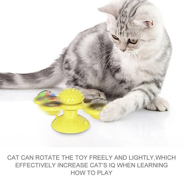 Playful cat interacting with blue Windmill Toy, suctioned to a smooth floor for secure fun