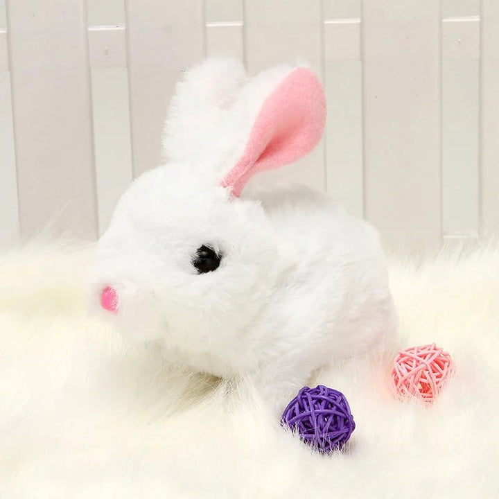 Musical plush bunny toy on a bedside table, a comforting soft toy for kids