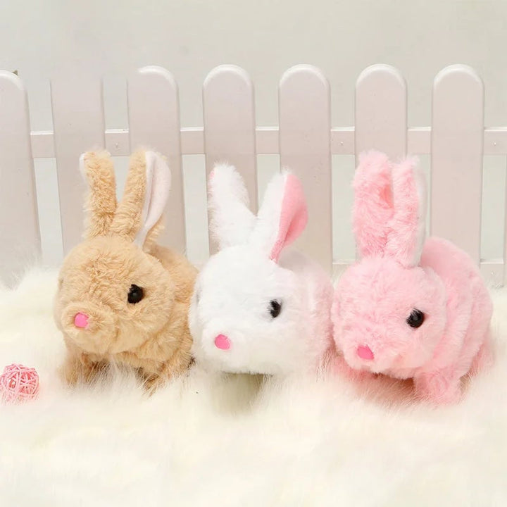 Smiling child hugging the soft, sounding plush bunny, ideal as a children's gift