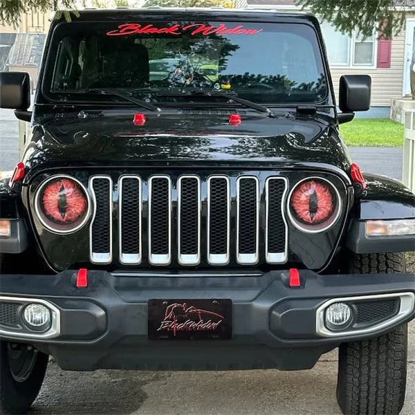 Side view of a Jeep showcasing Beast Eyes custom headlight decals; auto styling, car accessory