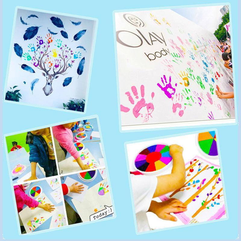 Close-up of a child's hand finger painting with bright primary colors from the Creative Art Kit