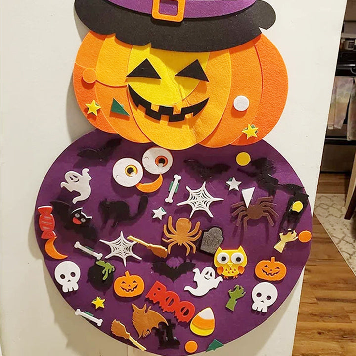 Close-up of a child's hands assembling a felt Halloween witch on a pumpkin base, garden decor craft