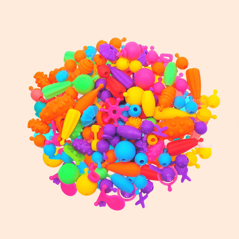 Opened Kids' Snap Pop Beads DIY Kit showcasing various shapes and colors of beads, perfect for jewelry creation